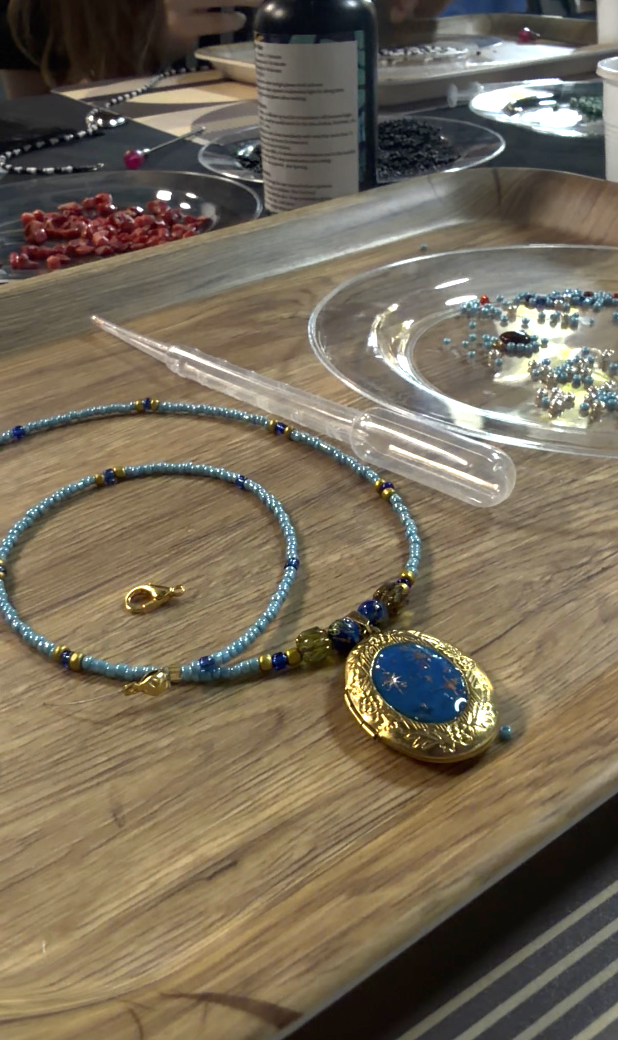 Blue locket on beads
